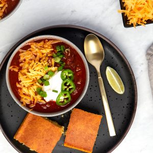 bowl of chili with a side of cornbread.