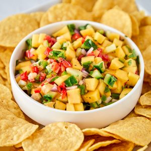 mango salsa in a bowl served with chips