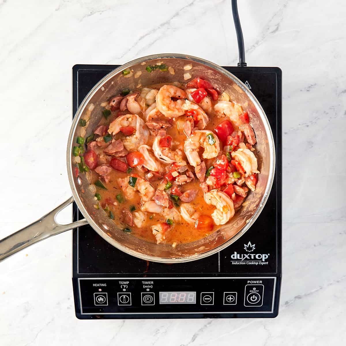 shrimp and sauce in a pan being cooked