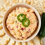 pimento cheese in a bowl with crackers surrounding the bowl