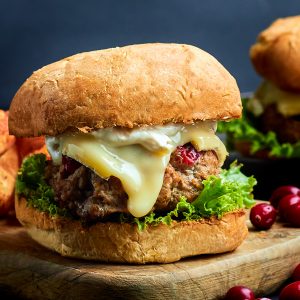 cranberry brie turkey burger on a wood serving board