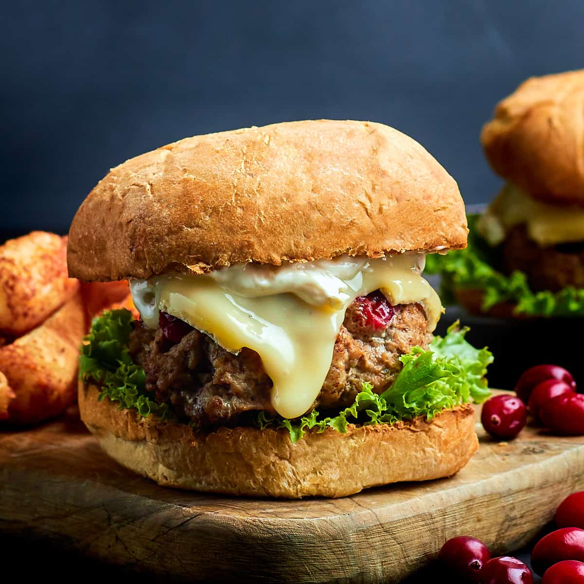 cranberry brie turkey burger on a wood serving board