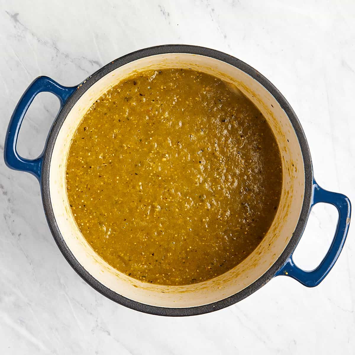 hatch pepper tomatillo sauce in a Dutch oven after being blended together