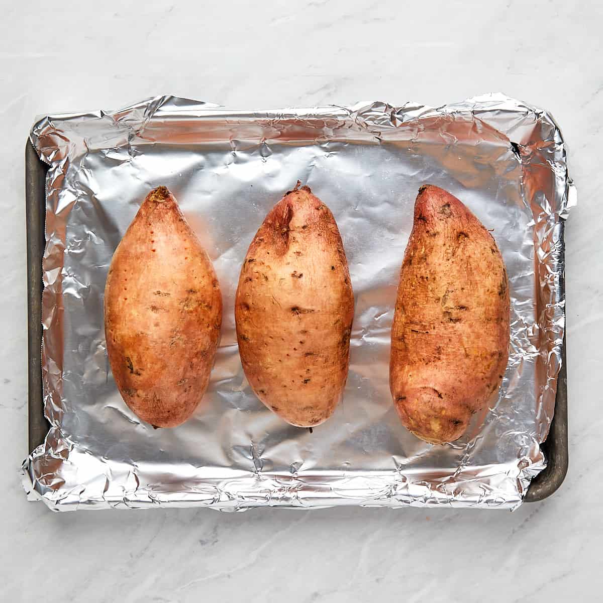 sweet potatoes on a cookie sheet
