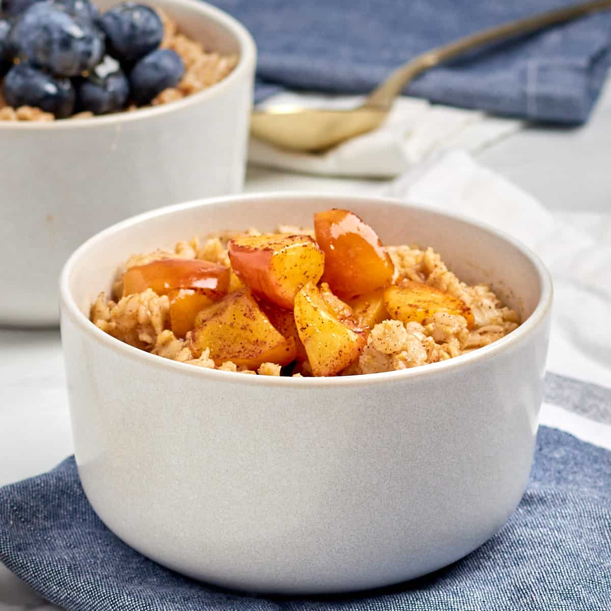 cinnamon spice oatmeal in a bowl topped with cinnamon apples