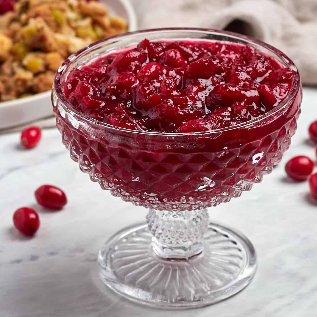 orange cranberry sauce in a glass serving bowl
