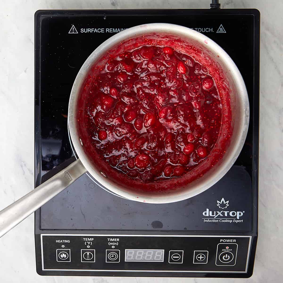 cranberry sauce simmering in a saucepan
