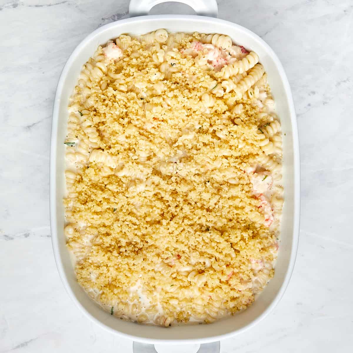 uncooked lobster mac and cheese in a casserole dish