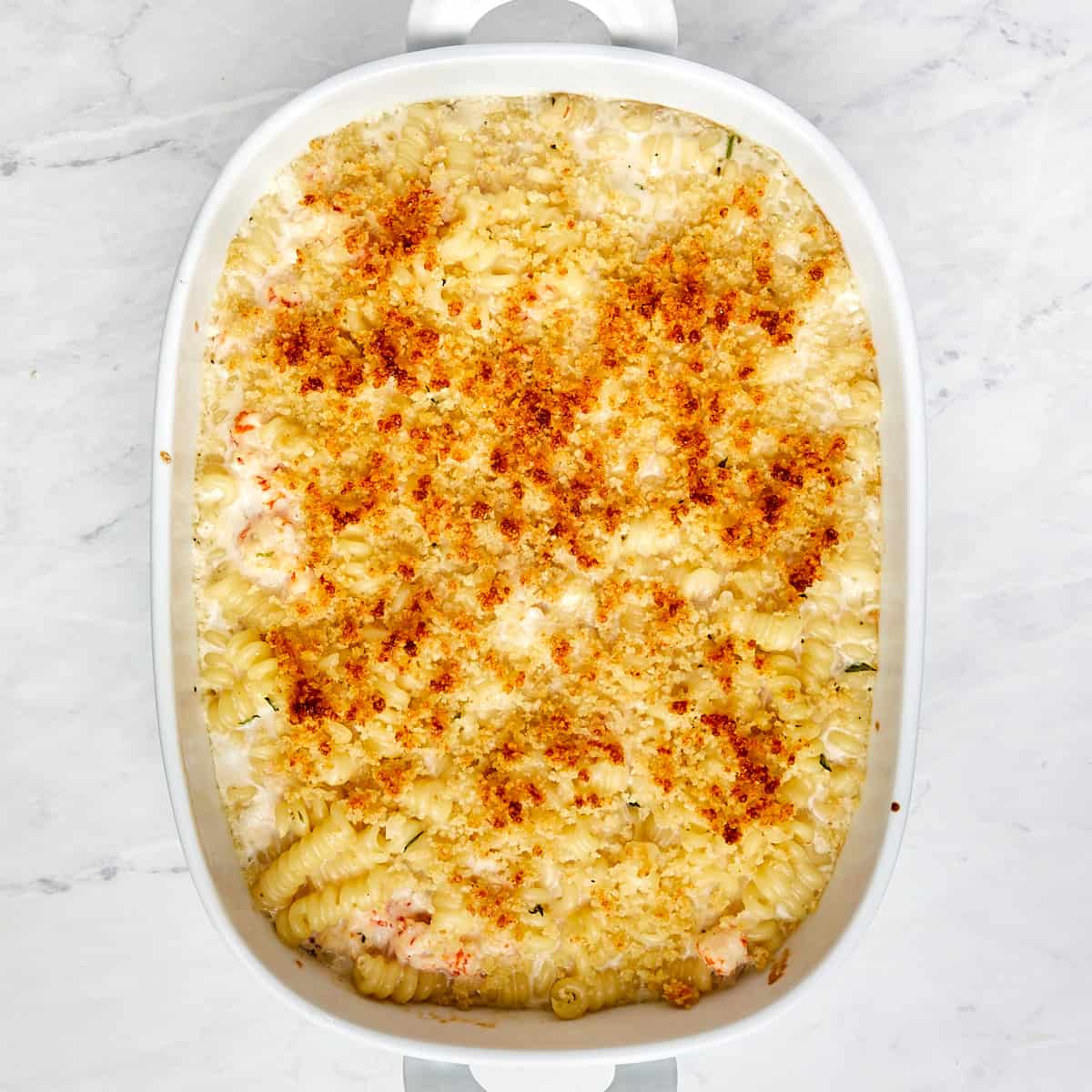 cooked lobster mac and cheese in a casserole dish