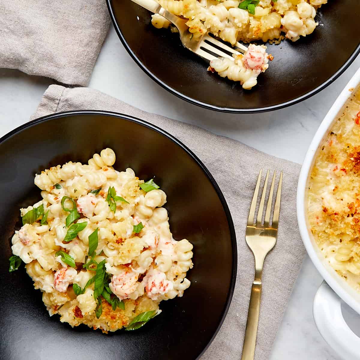 lobster mac and cheese served in a black bowl