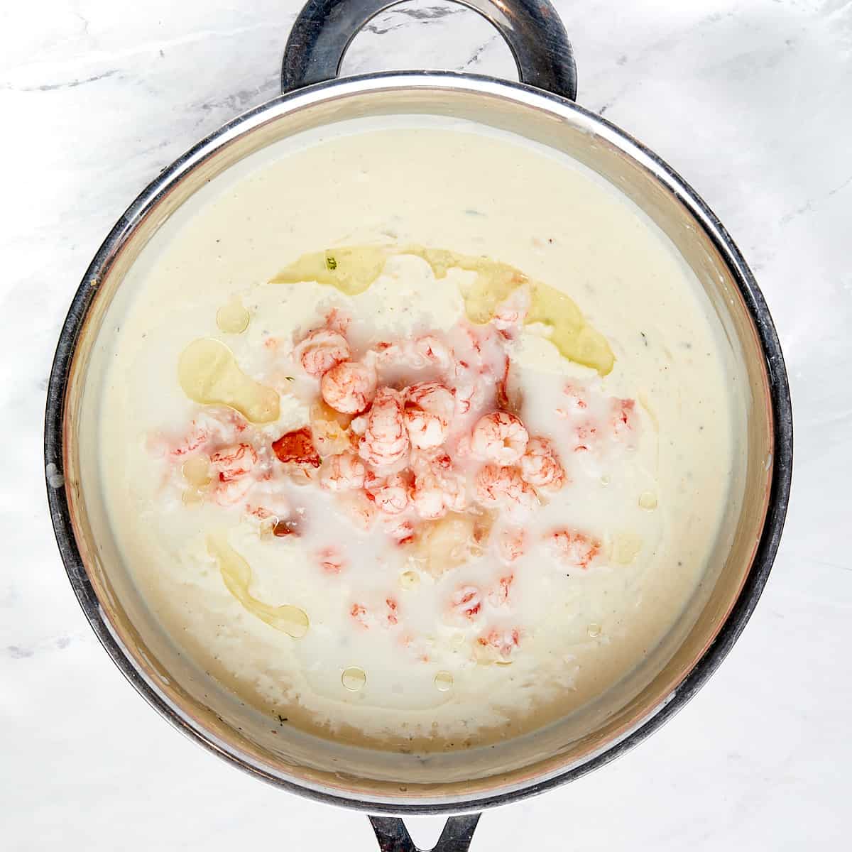 lobster and truffle oil added to skillet with cheese sauce