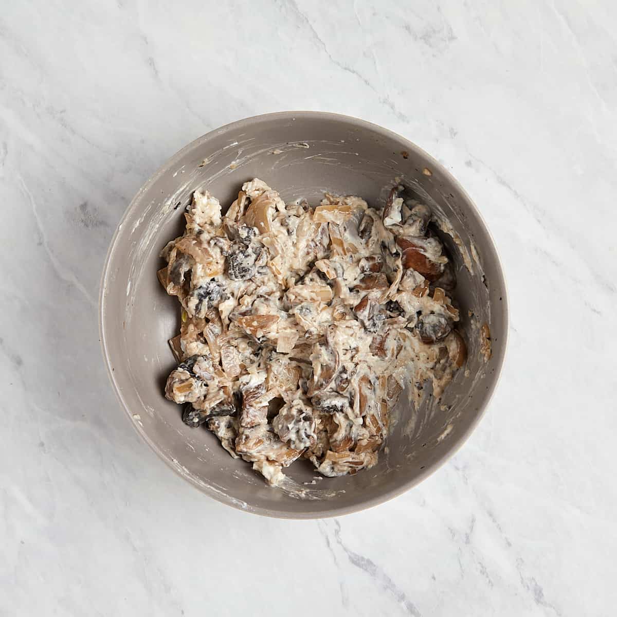 mushroom, shallot, and cheese mixture that has been combined in a bowl