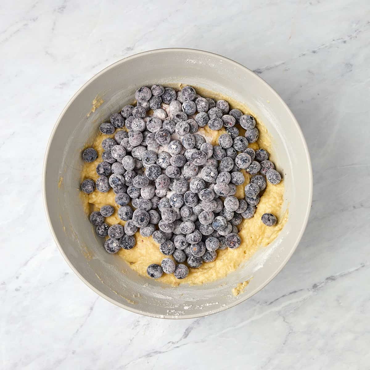 floured blueberries added to cake batter.