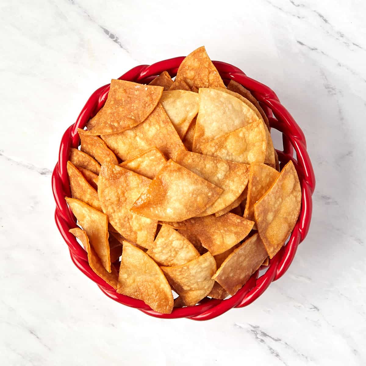 fried tortilla chips in a red bowl