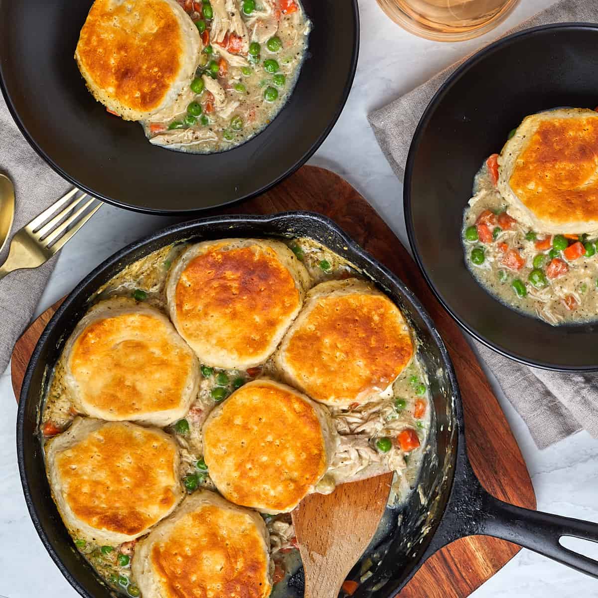 two servings of chicken pot pie in black bowls.