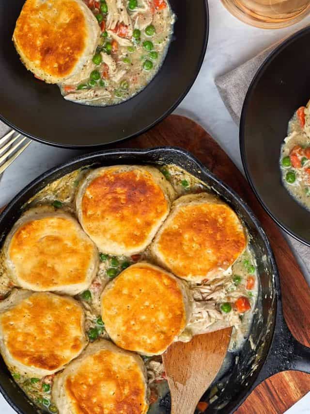 two servings of chicken pot pie in black bowls.