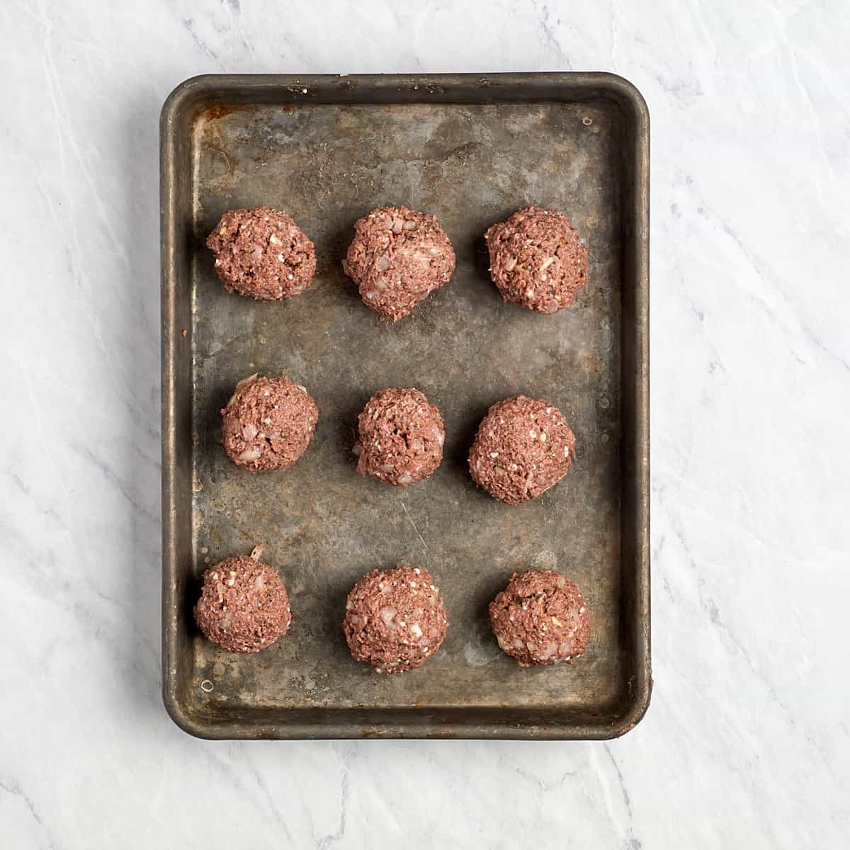 vegetarian meatballs portioned into one ounce balls sitting on a cookie sheet.