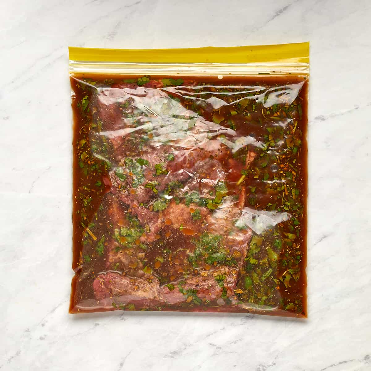 skirt steak in a ziplock bag with marinade