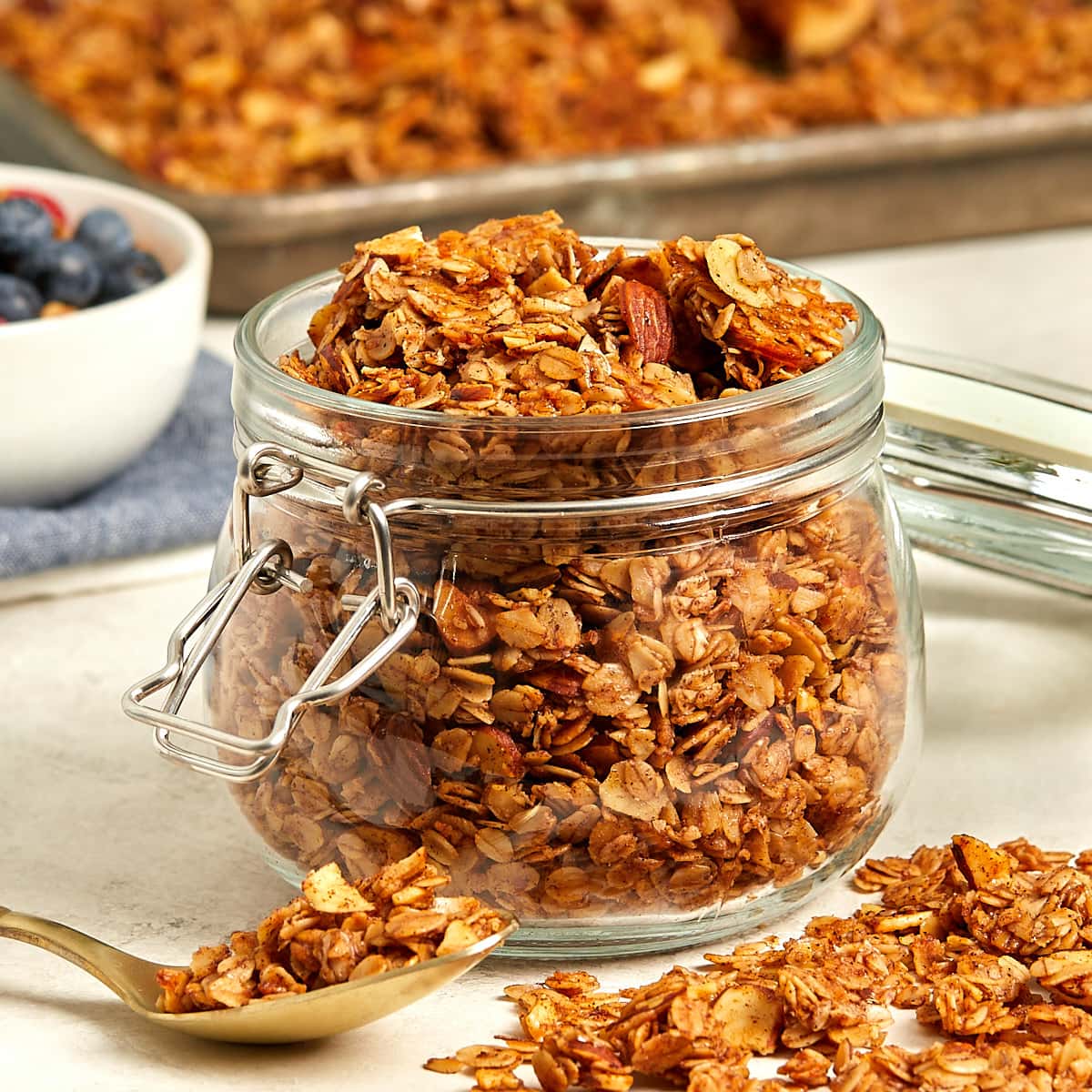 cooked granola in a glass storage container.