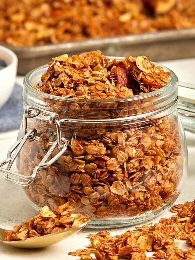 cooked granola in a glass storage container.