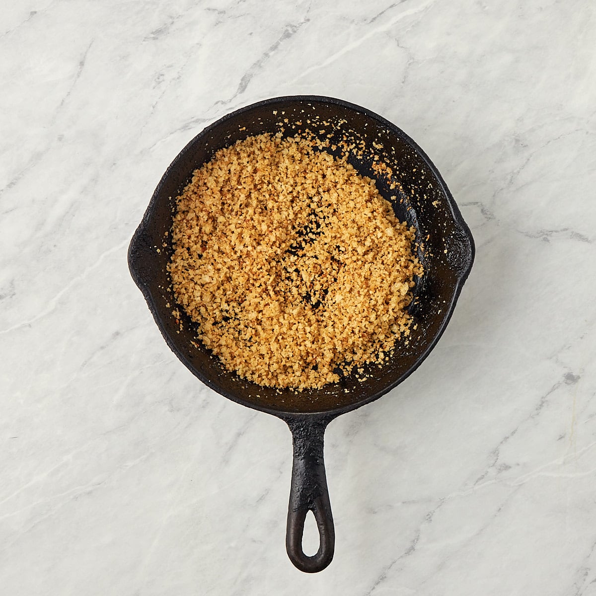 toasted panko bread crumbs in a cast iron skillet.