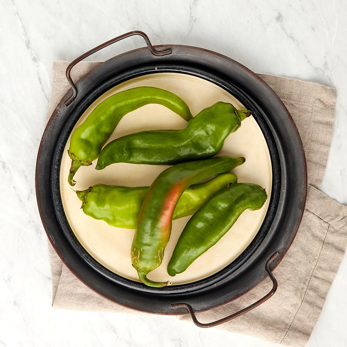 fresh hatch chiles on a plate.