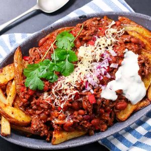 chili cheese fries on a plate.