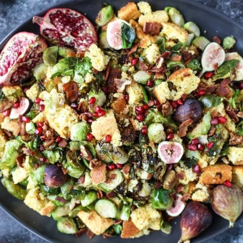 brussel sprout panzanella on a black plate.