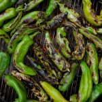 hatch chiles roasting on a grill.