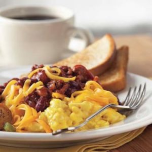 chili cheese scramble on a plate with a side of toast.