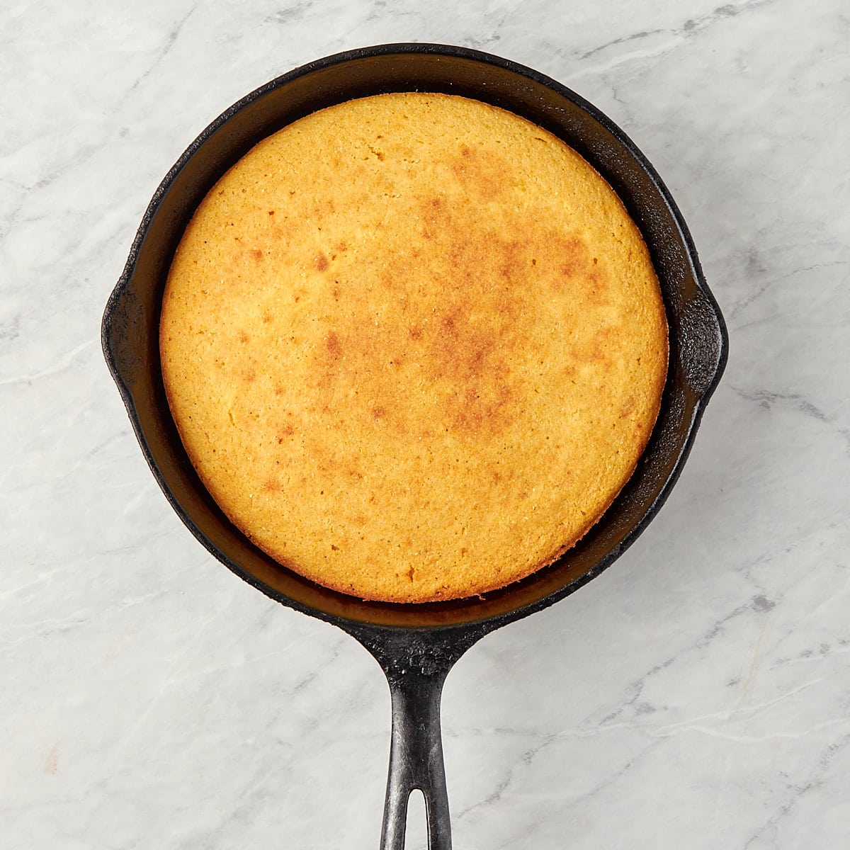 cooked cornbread in a cast iron skillet.