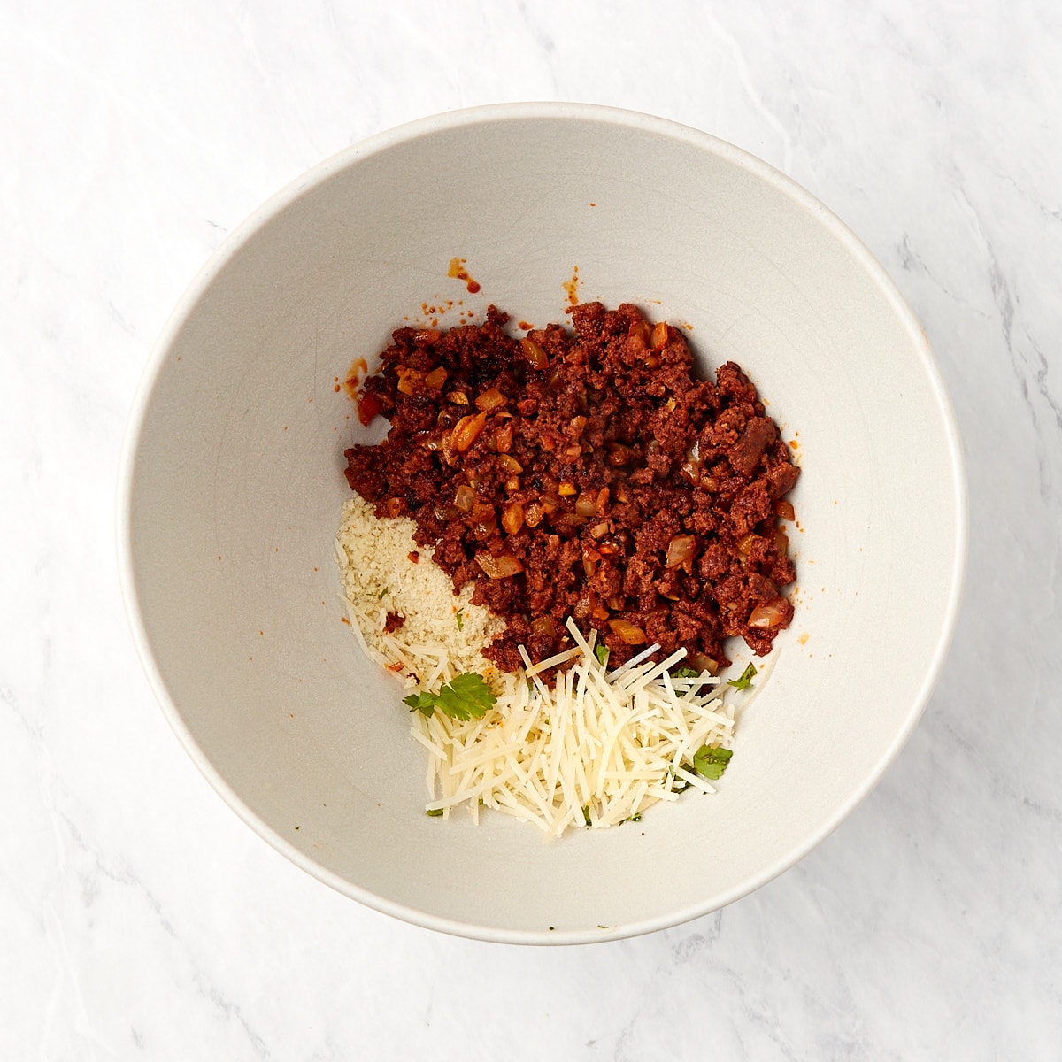 chorizo, breadcrumbs, and parmesan in a bowl.