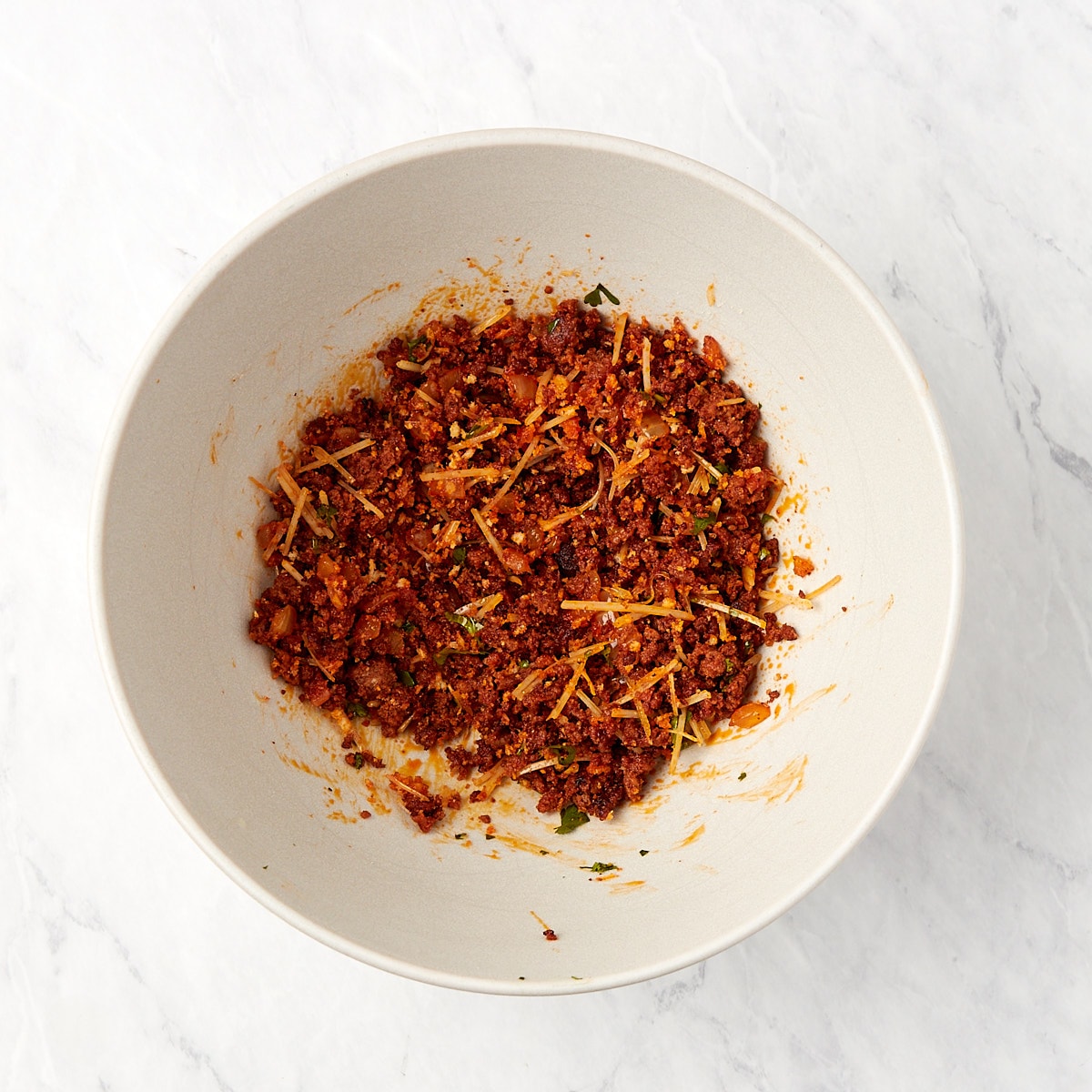 chorizo, breadcrumbs, and parmesan combined in a bowl.