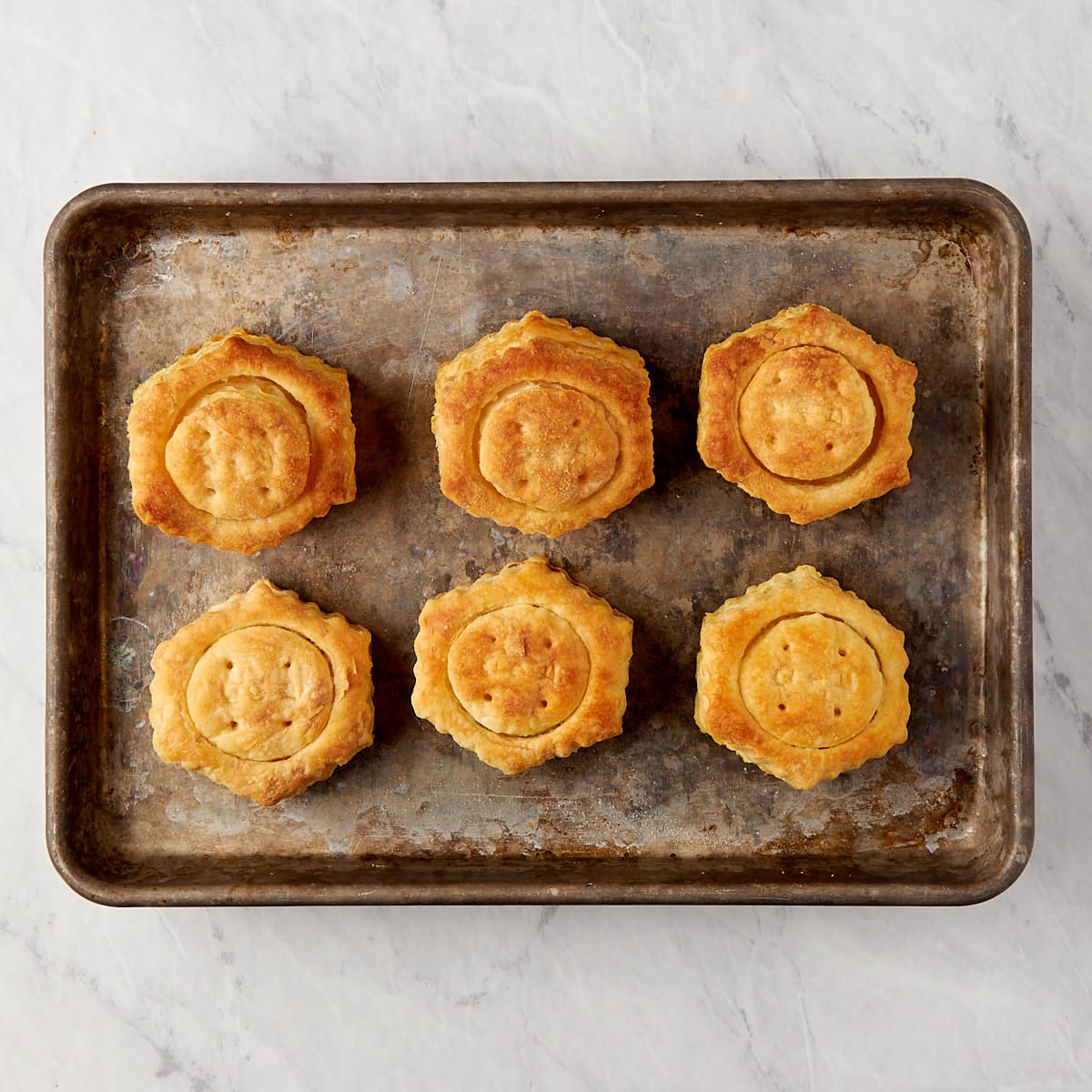 baked puff pastry shells on a baking sheet.