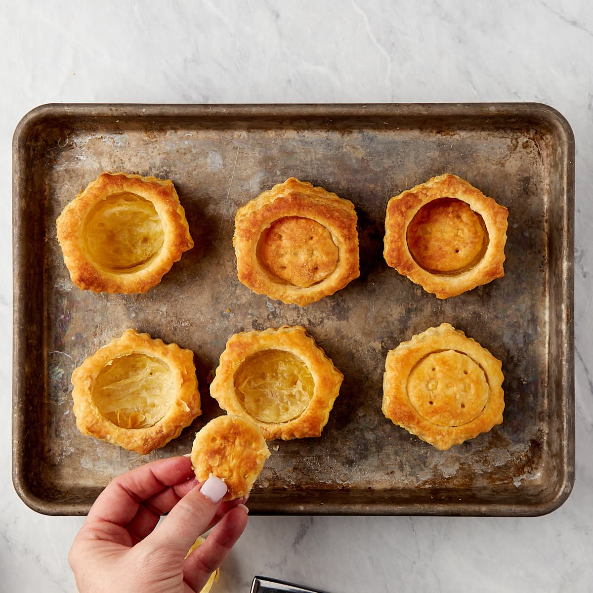 "top" being removed from baked and cooled puff pastry shells.