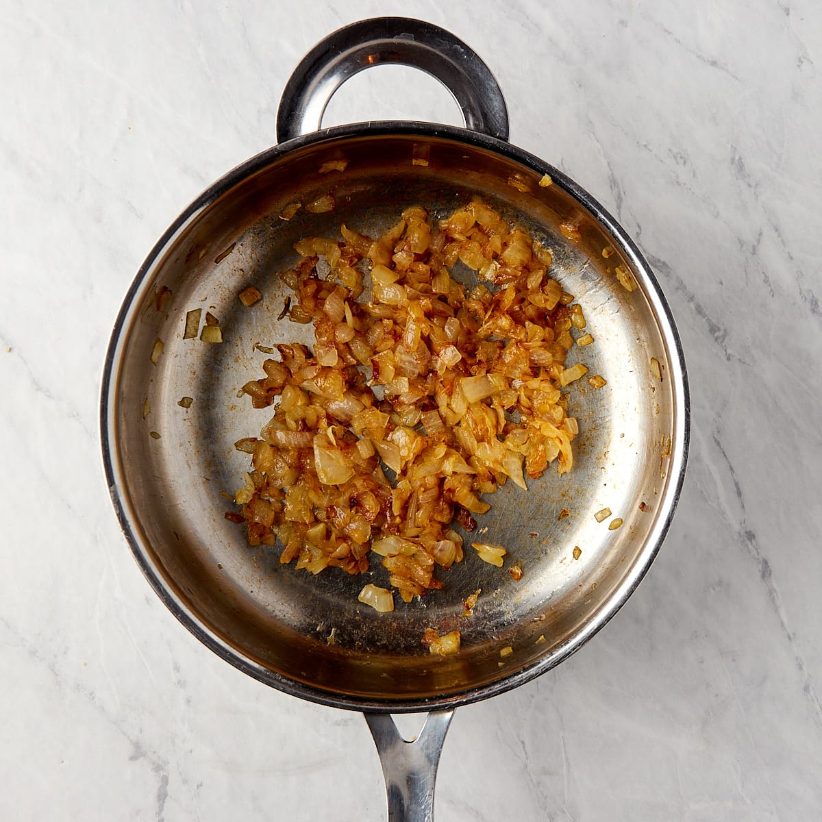 golden brown caramelize onions in a skillet.