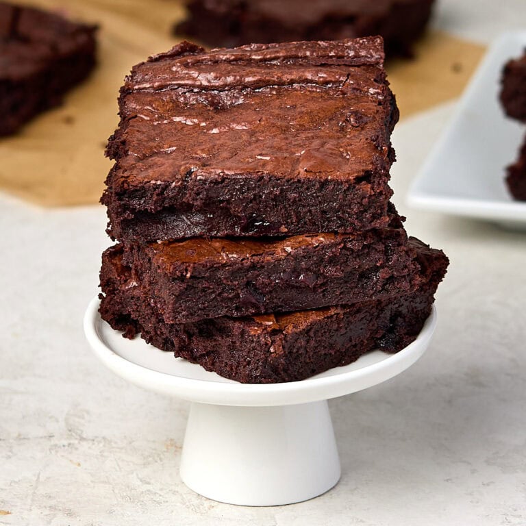 a stack of three chocolate cherry brownies on a small stand.