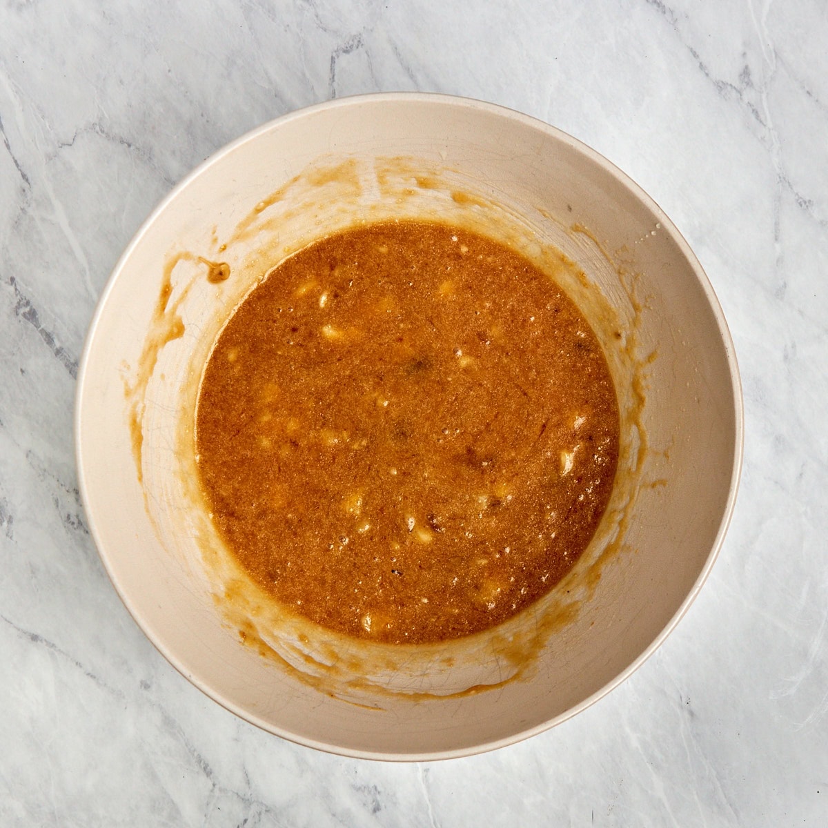 mashed bananas, brown sugar, eggs, and vanilla in a medium bowl.