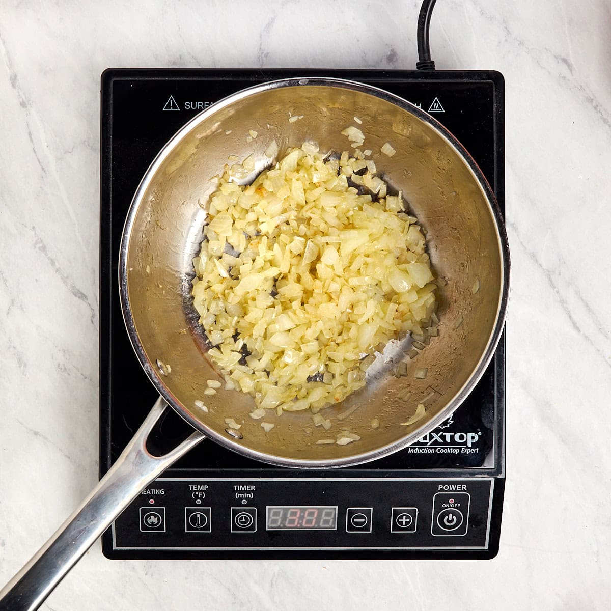 onions sautéing in a saucepan.