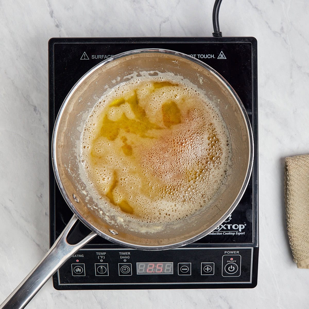 brown butter in a metal saucepan cooking.