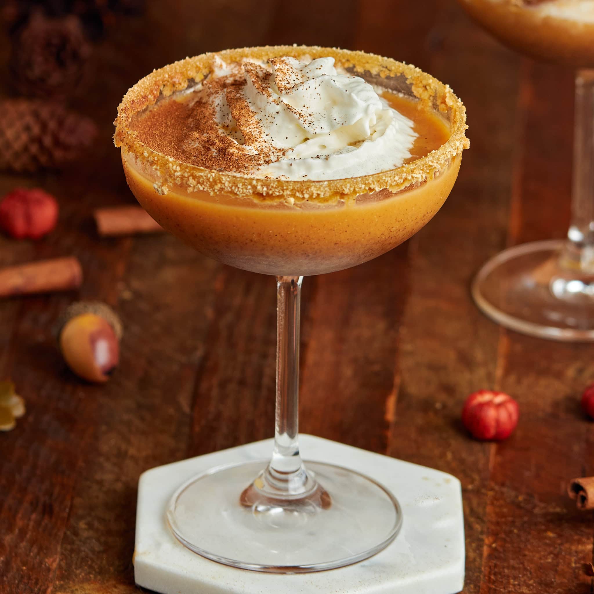 pumpkin pie martini with whipped topping in a coupe glass.