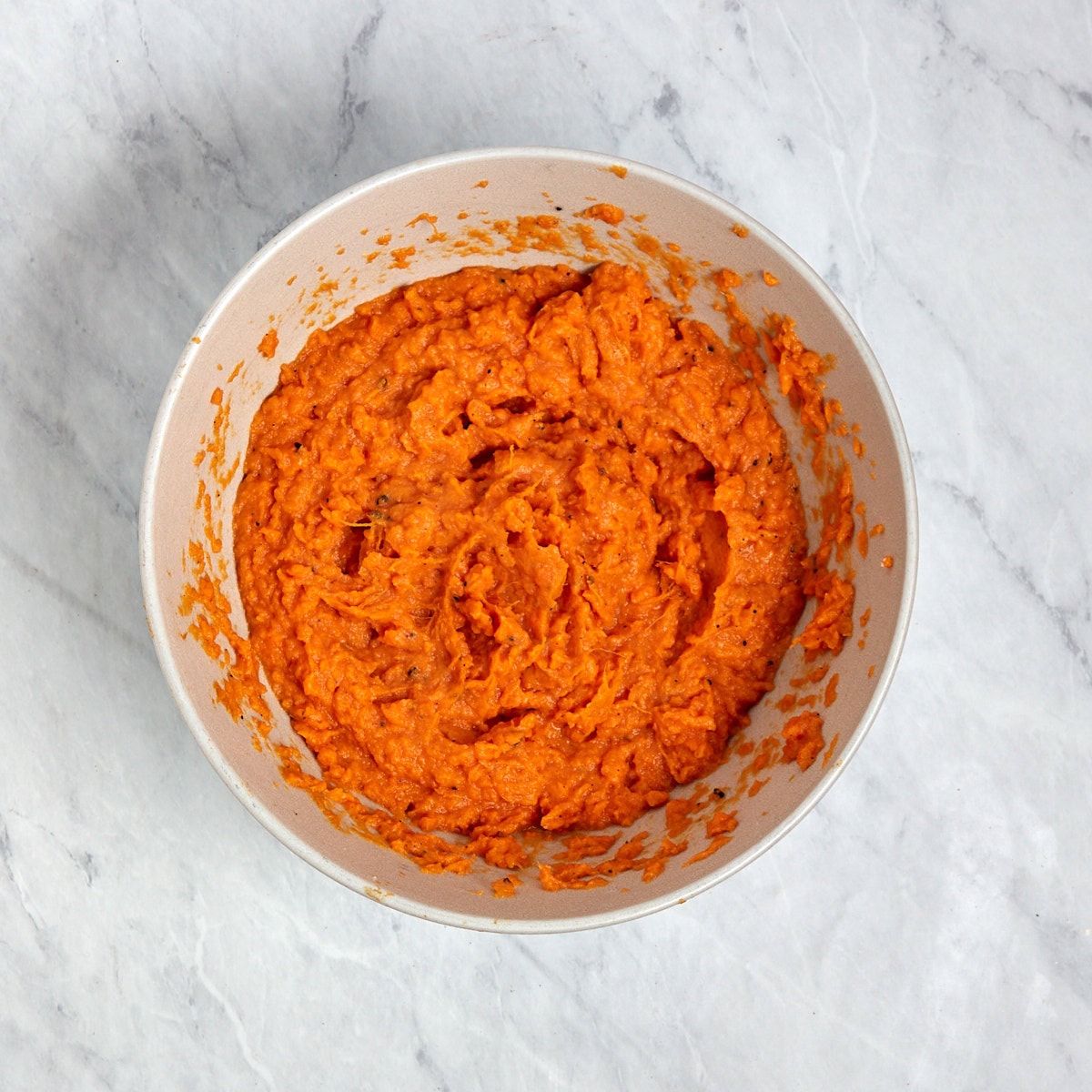 whipped sweet potatoes in a mixing bowl.