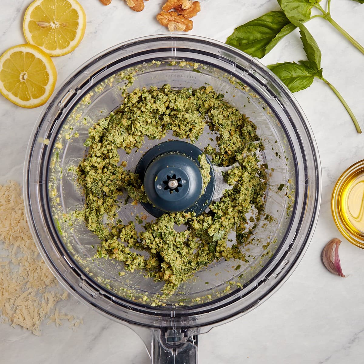 basil added to the food processor with the walnuts and garlic.