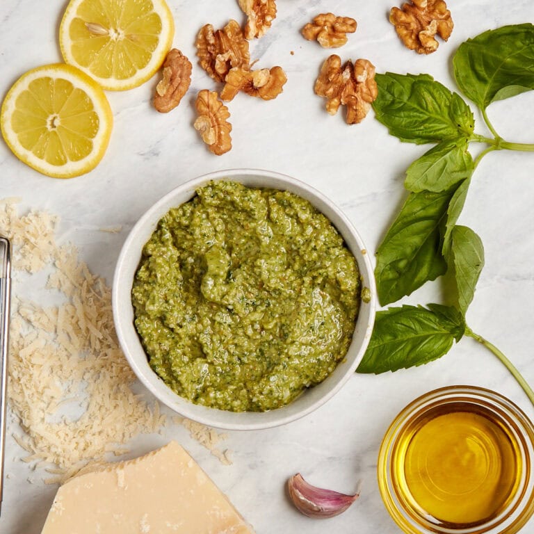 white bowl filled with basil walnut pesto.