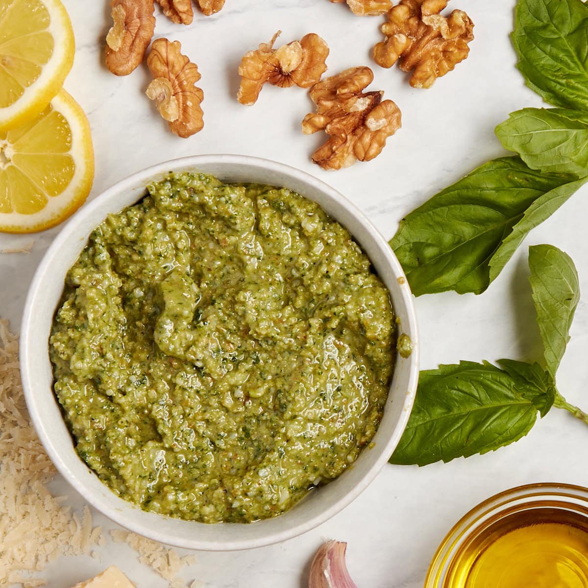 white bowl filled with basil walnut pesto.