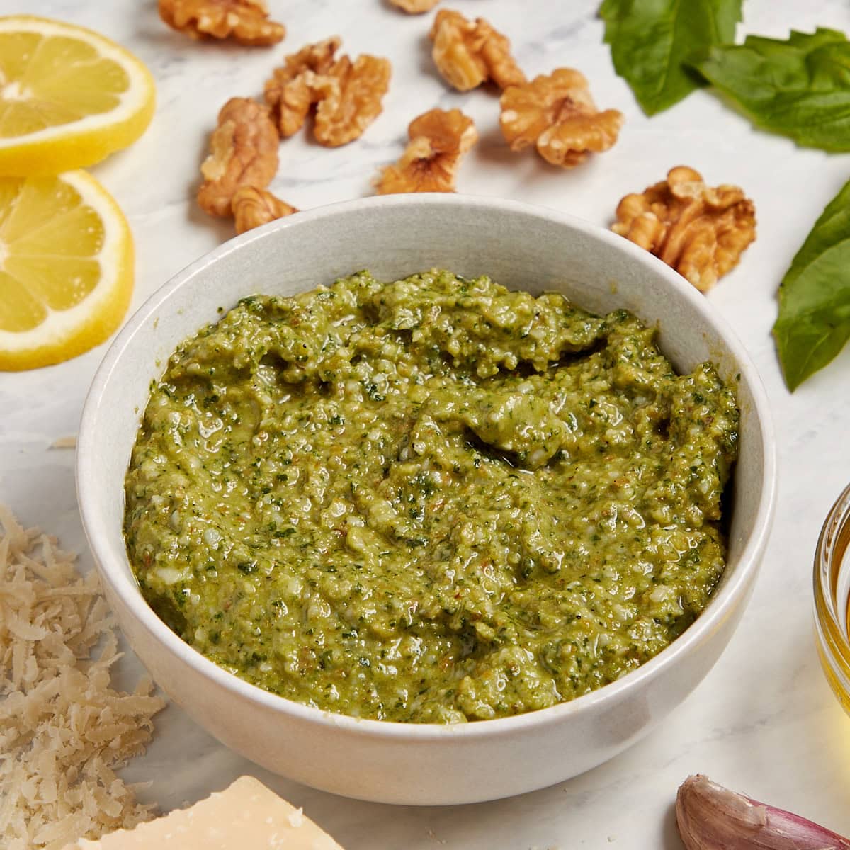white bowl filled with basil walnut pesto.