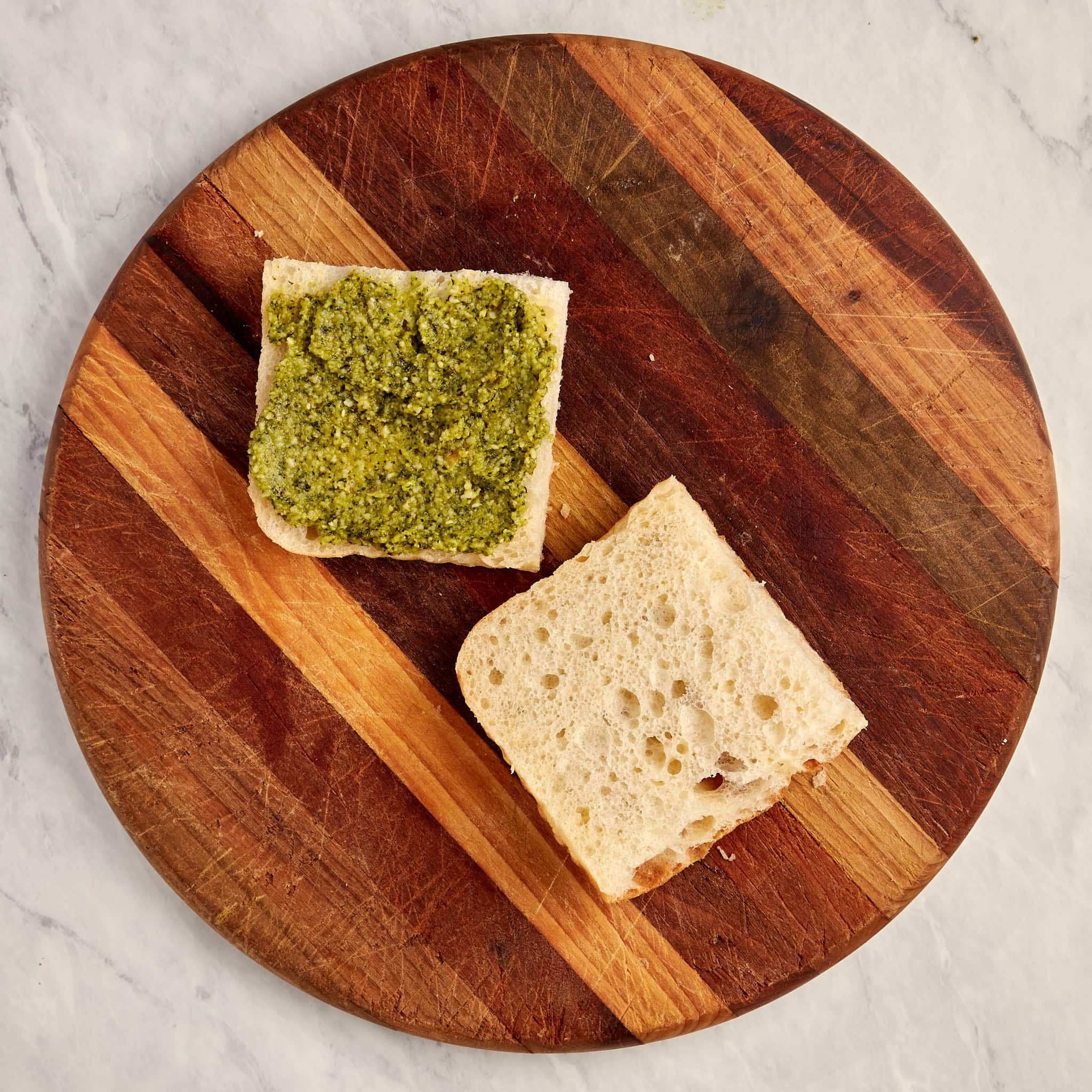 sliced bread with basil pesto on one side.