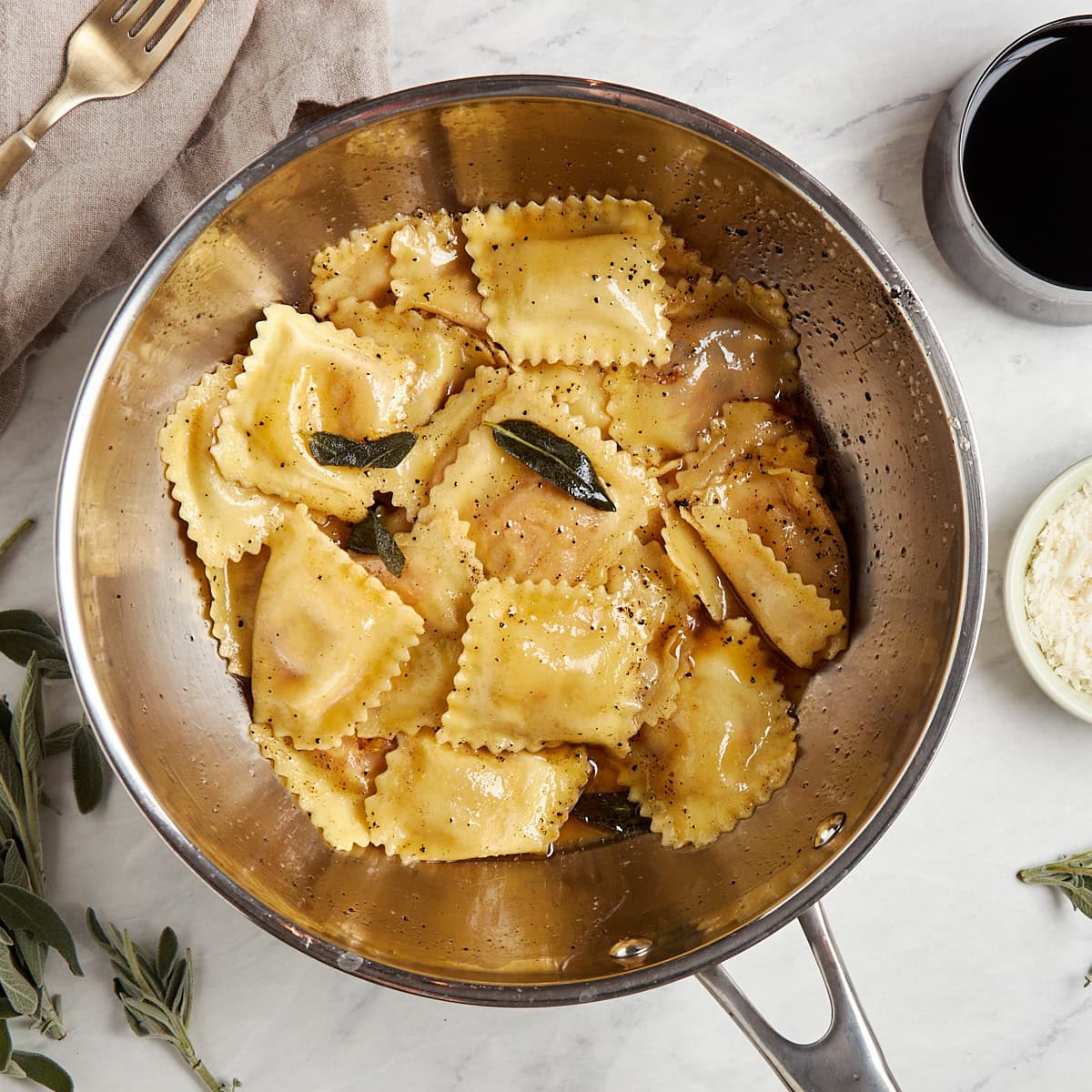 ravioli and sage brown butter in a sauce pan.