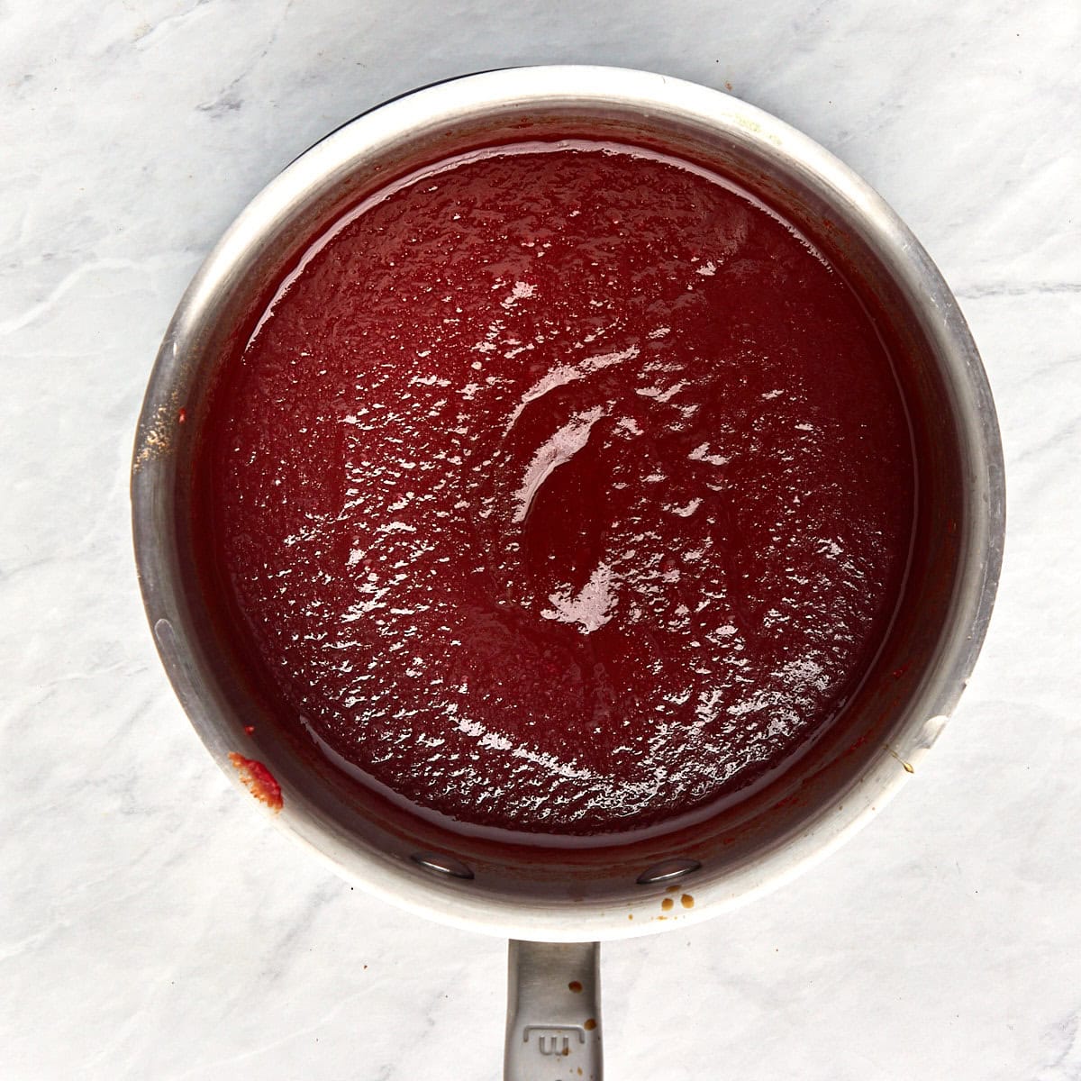 tomato paste, Worcestershire sauce, apple cider vinegar, and honey cooking in a saucepan.
