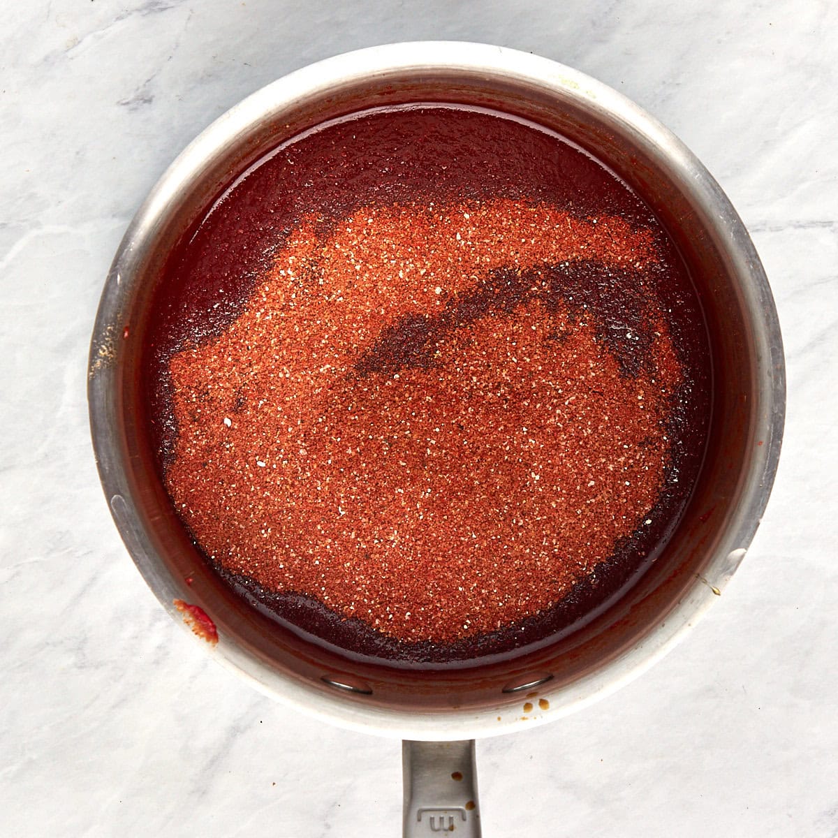 bbq seasoning added to the bbq sauce in the saucepan.